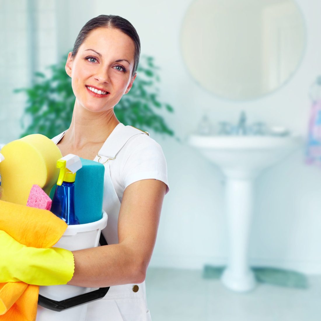 Young smiling maid. House cleaning service concept.